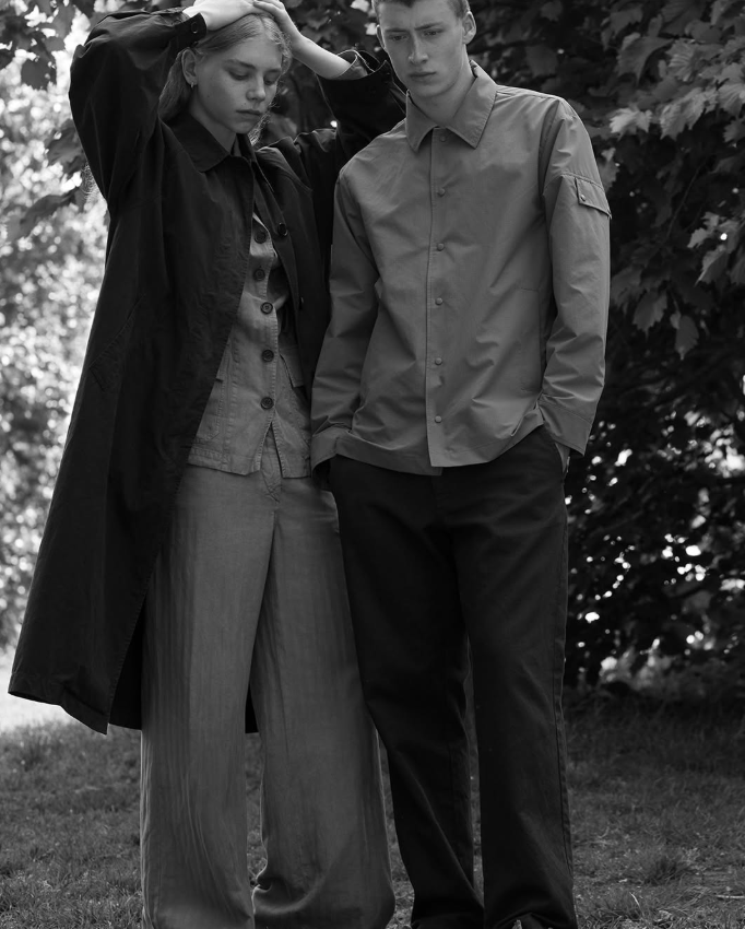 Minimalist black-and-white portrait of a man and woman wearing refined, utilitarian-inspired outerwear by Aspesi.