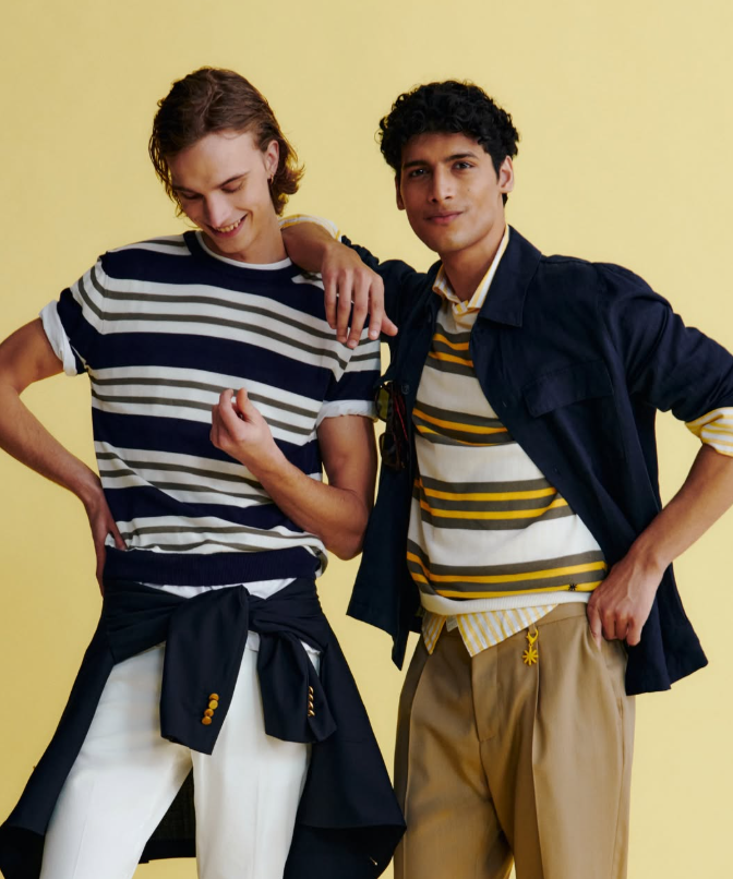 Stylish male models wearing vibrant striped outfits by Manuel Ritz,featuring bold navy, white, and yellow color combinations, the look blends classic menswear with contemporary flair. 